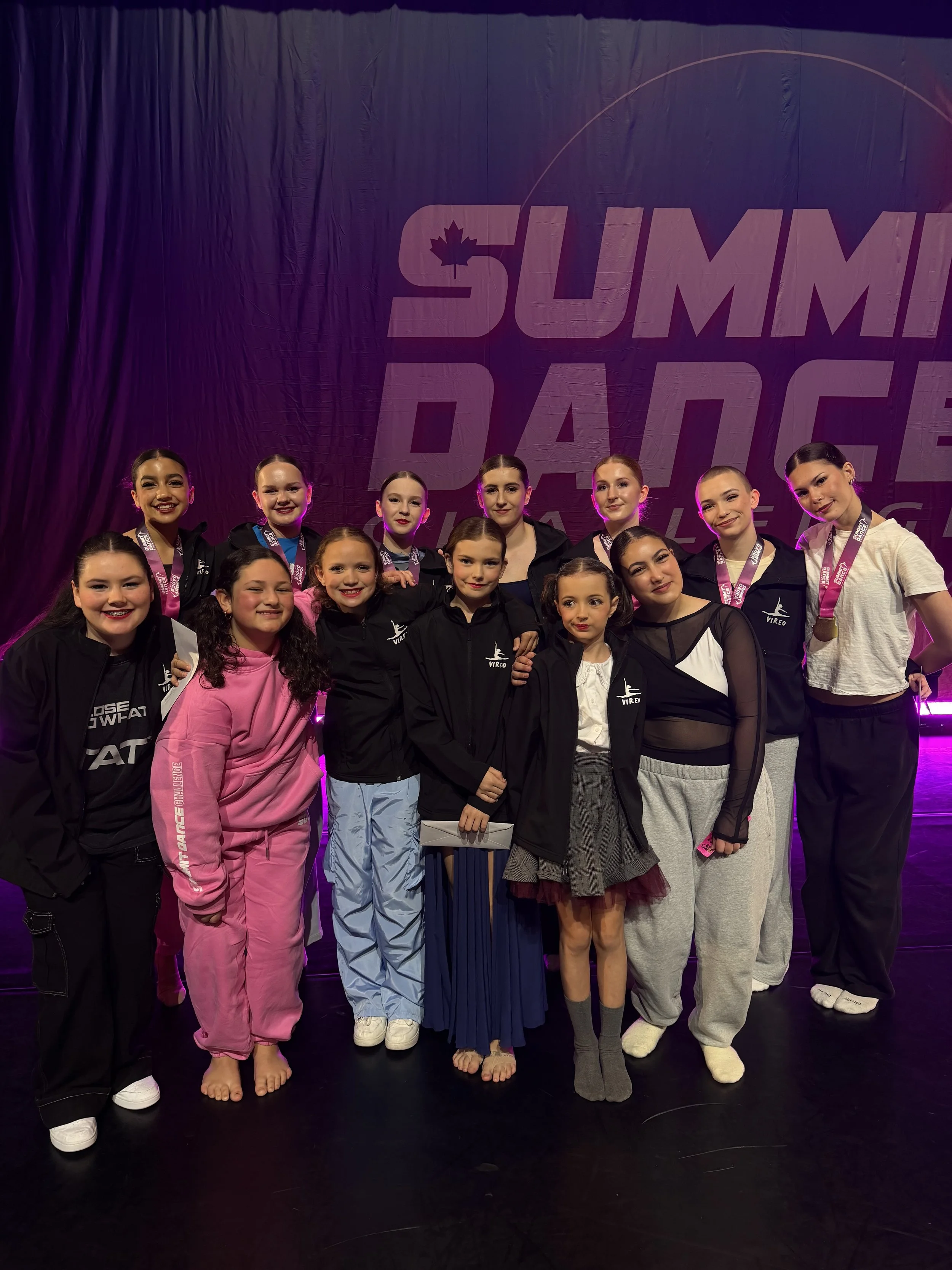 A group of young female dancers on stage at a competition