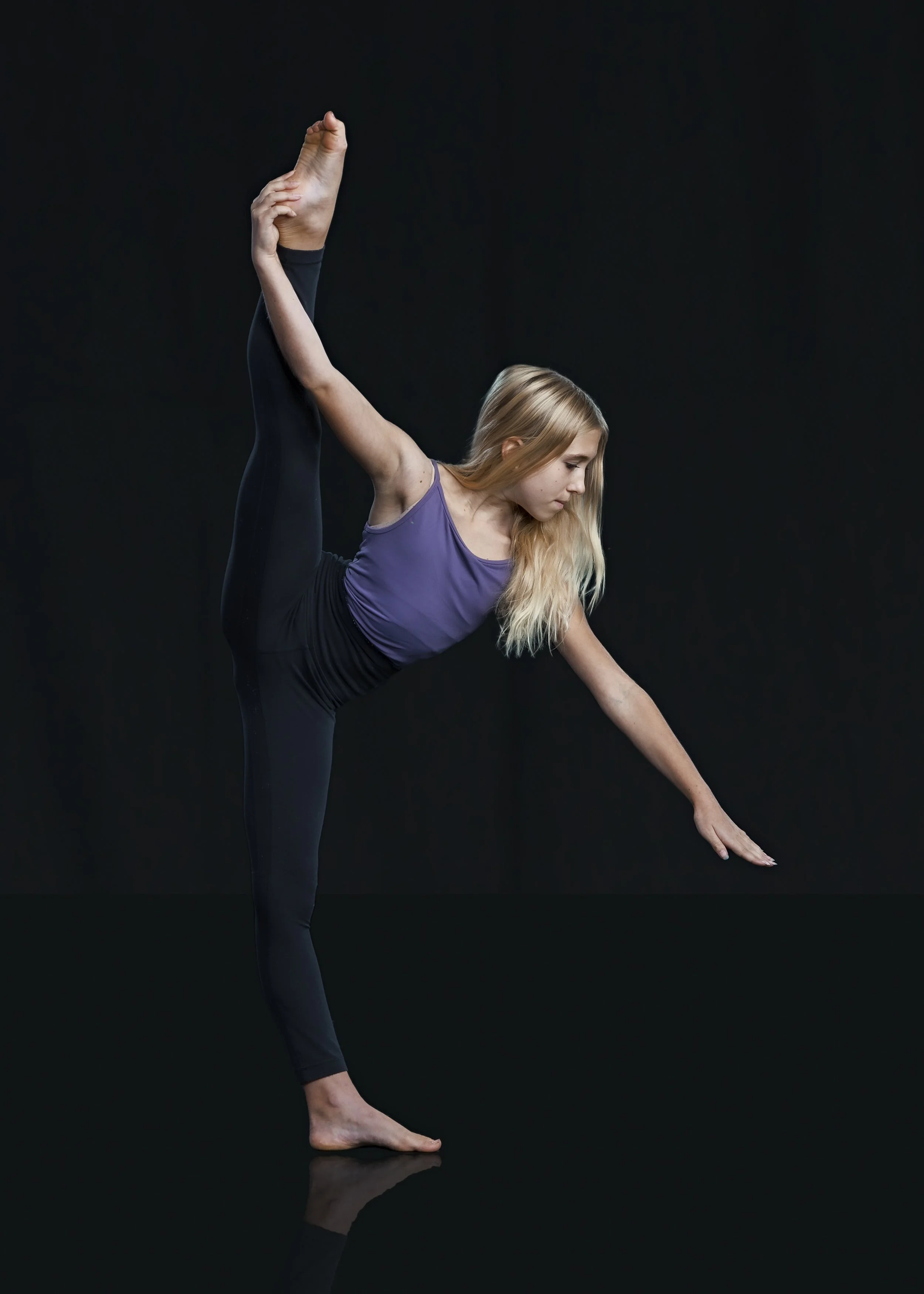 Dancer holding their right leg extended to the side while balancing