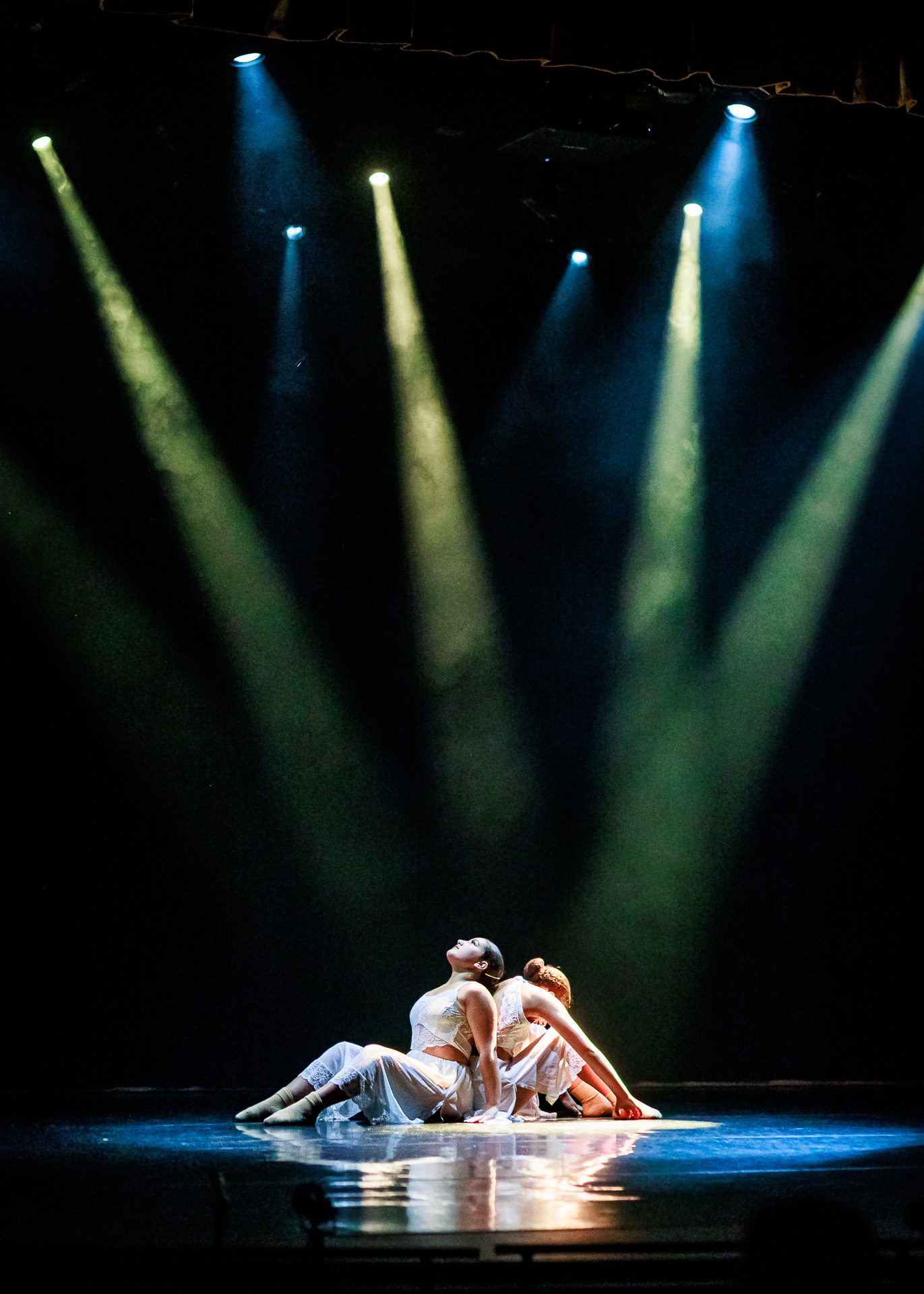 Two dancers performing on stage under dramatic stage lighting at VIREO School of Performing Arts